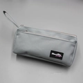 Detail view of the gray oxford cloth stationery bag with zip and Almost Blue logo - Gray