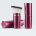 Macro detail of portable telescopic makeup brush showing retractable pink metal case and soft bristles - Wine Red Slant Head