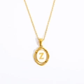 Macro shot of gold stainless steel necklace featuring an oval pendant with letter Z - Letter Z - Gold