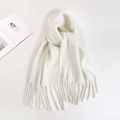 Solid white mohair scarf with tassels displayed on a white background with a magazine - White