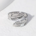 Adjustable silver feather ring in stainless steel with detailed plume texture on white base - Size 7 (Adjustable) / Steel