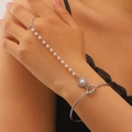 Detail of silver pearl hand chain featuring knotted cuff and rhinestone accents - 61 White K M-002