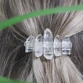 Handmade natural clear crystal hair clip with woven metal wire on a female model - White Transparent Silver