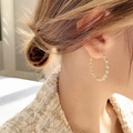 Elegant gold hoop earrings with white pearls shown on a female model for classy style - Pearl Pave Large Hoop