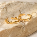 Close-up of 18K gold plated wave ear cuffs with white pearls and zircons on stone - Gold Artificial Pearl Wave Ring