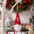 Red knitted Christmas gnome ornament featuring a white embroidered letter V on the hat - Letter V Style
