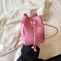 Mini pink woven drawstring bucket bag with leather texture and thin shoulder strap - Pink