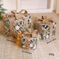 Three-piece beige light-up Christmas gift boxes with brown burlap bows and LED lights - Snowflake Pine Needle Gift Boxes 3Pcs