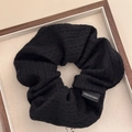 Detail of black knitted scrunchie with woven texture and Made in Korea label - Black