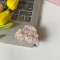 Floral claw clip with purple marble pattern and pink rhinestone center on laptop - Purple Floral