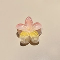 Macro view of gradient pink and yellow plumeria hair claw clip with pearlescent glitter finish - Colorful Plumeria Orange Yellow