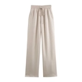 Détail du pantalon plissé abricot avec taille élastique à cordon et texture riche - S / Pantalons / Abricot
