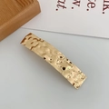Close-up of golden geometric rectangular hair clip with hammered metal texture design - Square Gold