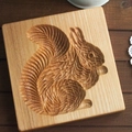Square beechwood cookie mold featuring a detailed carved squirrel pattern in natural wood - Fluffy Squirrel