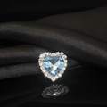 Macro shot of heart-shaped light blue crystal with white zircon border on black silk - Light Blue