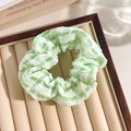 Green checkered floral scrunchie hair tie displayed on a vintage jewelry wooden tray - Plaid Green
