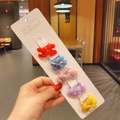 Set of 10 colorful cartoon bow hair ties for girls on a white display card - Style 10 Bow Tie Set