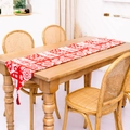 Roter Weihnachts-Tischläufer mit weißen Rentier-Mustern und roten Quastenanhängern - Rot und weißes Rentier