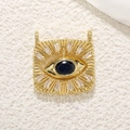 Macro shot of evil eye pendant with blue center stone and white zircon starburst - Ivory