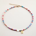 Detail of colorful beaded necklace featuring a golden N letter charm and heart pendant - Letter N