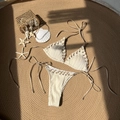 Two-piece ribbed cream bikini set with adjustable halter neck on a woven beach mat - S / Off White