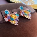 Macro detail of luxury heart-shaped earrings with colorful zircon gemstones - Colorful