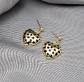 Elegant gold heart earrings with black star patterns on a grey silk background - Gold Black Flower Heart Hook Dangle