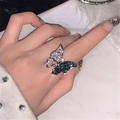 Macro shot of micro-paved blue and white zircon butterfly ring on a marble surface - Silver - Blue White Butterfly CZ