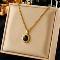 Vintage gold rope chain necklace featuring a black onyx oval pendant on a metal tray - Gold Rope Black Gem (N2246)
