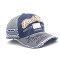 Detailed macro view of retro washed denim cap with distressed fraying and vintage embroidery - Adjustable / Blue