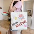 White canvas tote bag featuring a cute cartoon pig and chick print on a shoulder strap - Piggy Ballet