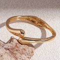 Detailansicht des goldenen Armreifs mit Wassertropfen-Design auf einem Stein - Bohnenform Scharnier Armband / Gold