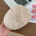 Beige beret with delicate white floral embroidery on a cozy wooden desk setting - Embroidered Flowers - Khaki