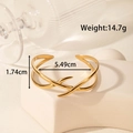 Golden hollow leaf stainless steel open bracelet with a minimalist crisscross design - Streamlined Cross