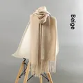 Thick beige winter cashmere scarf with fringe displayed on a modern white chair - Tassel Style / 220g (200x70cm) / Beige