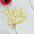 Close-up of a golden Happy New Year acrylic cake topper with a gift box icon - English Happy New Year Style 2 / Gold
