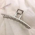 Macro shot of silver metal hair claw clip with rectangular frame and spring detail - Silver-Straight