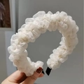 Close-up of white ruffled organza headband showing soft pleated fabric and textured detail - White
