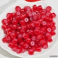 Detail view of red 6x8mm glass beads in a shell plate for DIY jewelry making - Red