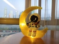 Luminous astronaut on moon pencil holder made of micro blocks on a wooden table - 6037 Moon Violinist Astronaut with Light