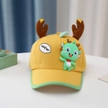 Detail of yellow toddler baseball cap with 3D brown antlers and a small green dinosaur - Yellow Antler Elf