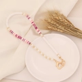 Detail of bohemian beaded phone strap with pink striped beads and golden heart clasp - Mixed Pink