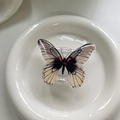 Macro view of butterfly phone grip with white resin finish and realistic black vein detail - Cow Pattern Butterfly