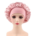 Close-up of pink satin hair bonnet with elastic wide band on a mannequin head - One Size / Dusty Pink