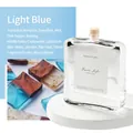 Light Blue reed diffuser with woody amber scent in glass bottle on white pedestal - Light Blue