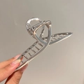 Detailed close-up of a large minimalist silver alloy hair claw clip in hand with high polish - Silver