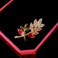 Macro shot of gold branch brooch with pink gemstones on black velvet padding - Branch Leaf Style (B881)