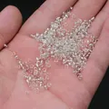 Hand holding silver-lined 2mm glass seed beads for DIY jewelry making and crafts - 3mm / 450g / White