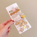 Candy colored hair clip set with pearl and smiley face charms held in hand - Smile (8 Piece Set)
