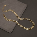 Detail of gold Cuban chain with blue accents on dark slate stone background - Gold Oval Link Chain with Blue Accents (8#)